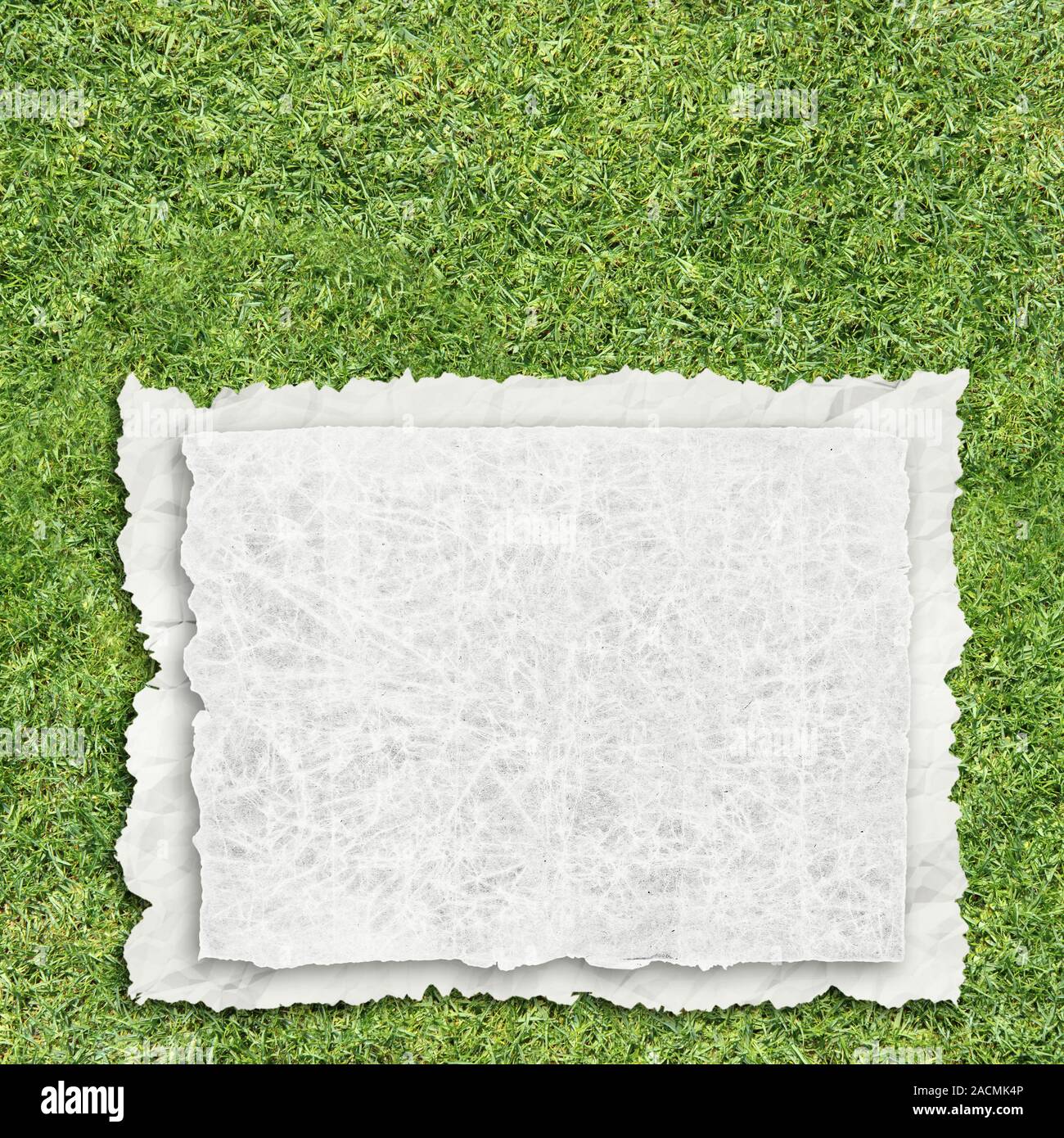 paper on grass Stock Photo Alamy