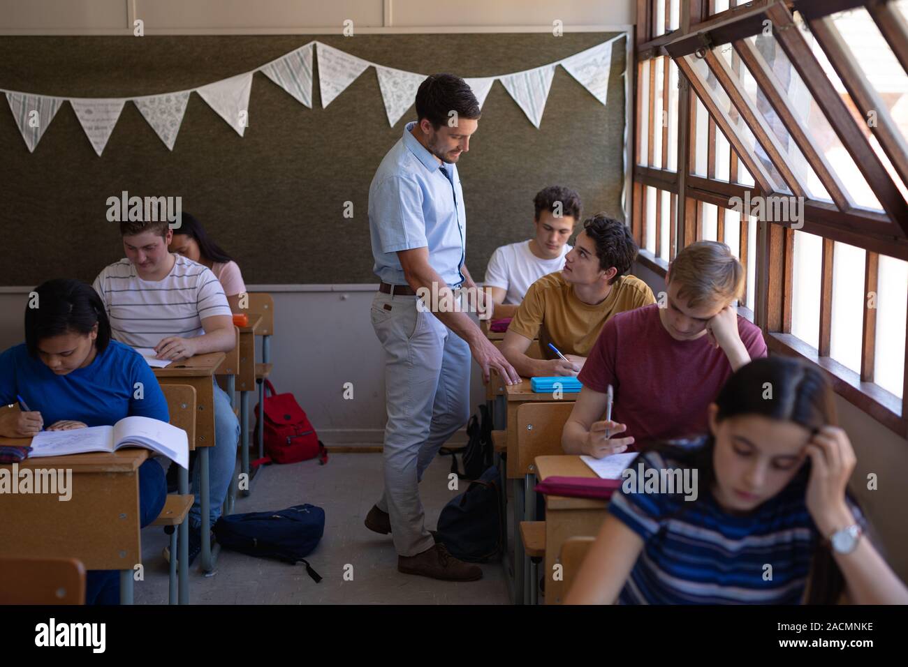 Teenagers in school classroom Stock Photo - Alamy