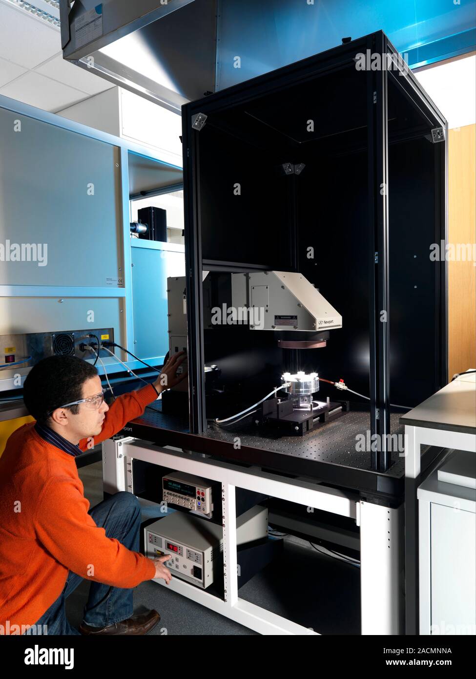 Soolar Cell Testing Testing solar panels. Researcher testing photovoltaic cells in various ...