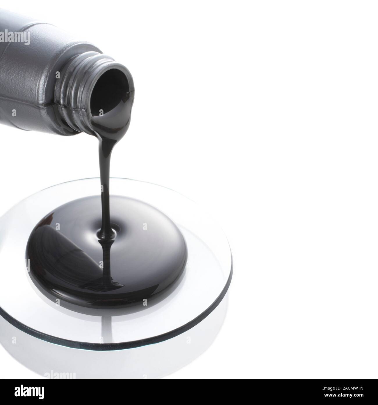 Molybdenumbased oil additive (Molyslip) being poured from a bottle