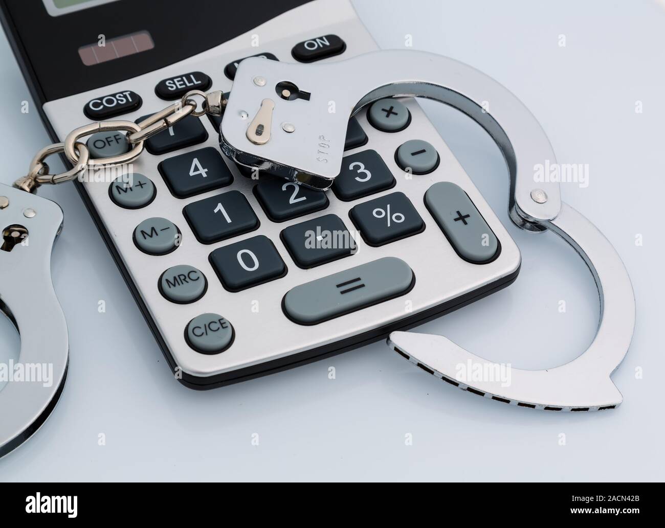 Calculators and handcuffs Stock Photo - Alamy