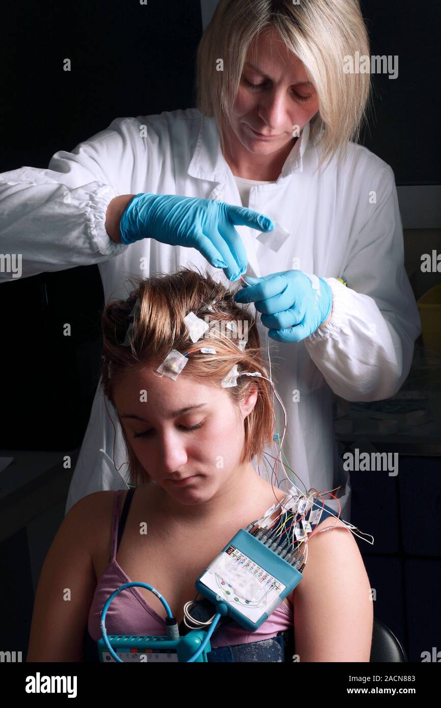 Electroencephalography. Neurologist placing electroencephalography (EEG