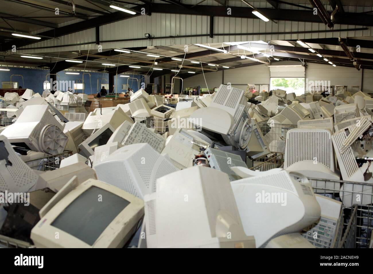 Computer equipment recycling centre. Pile of old computer monitors