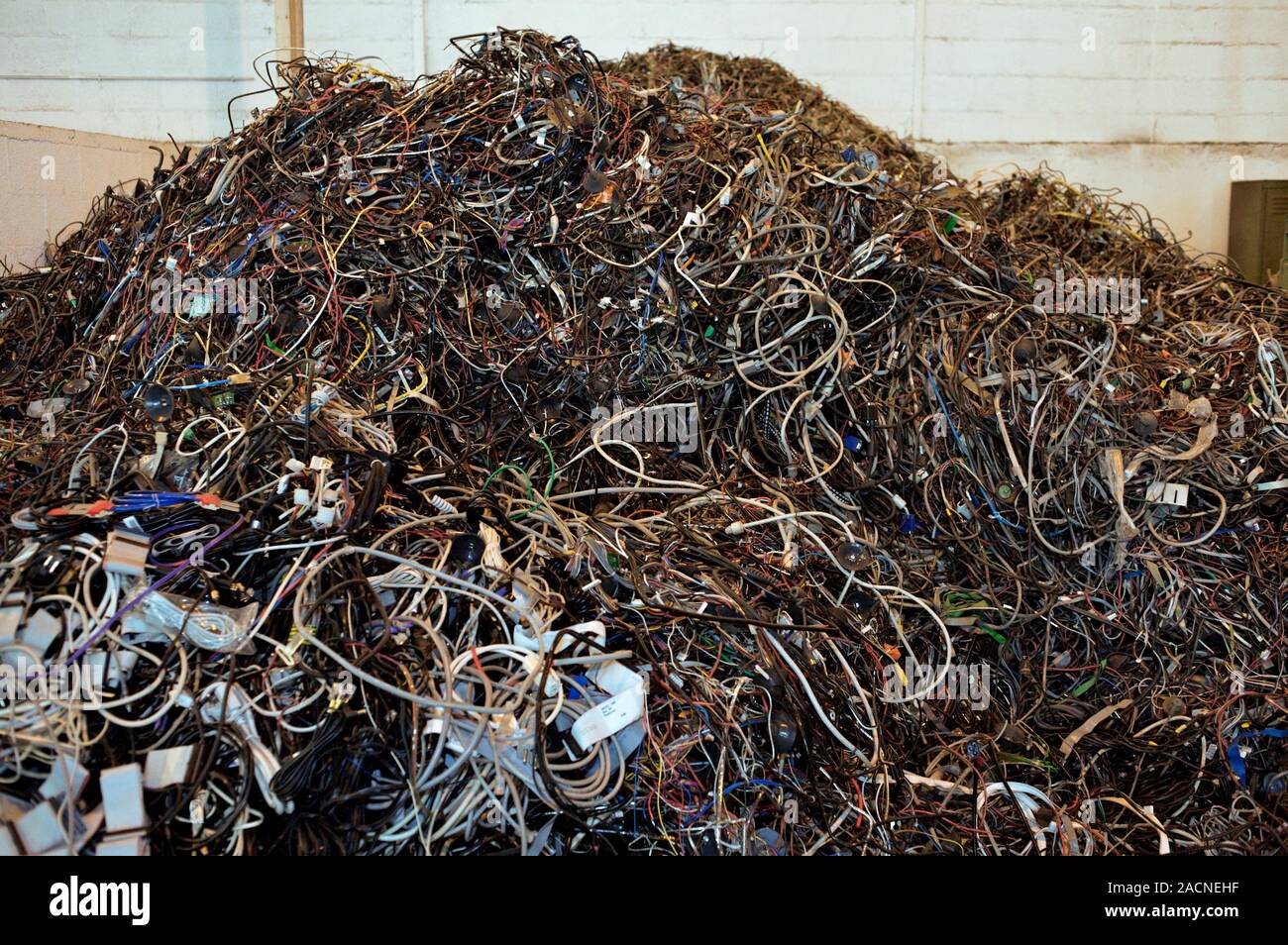 Computer equipment recycling centre. Pile of old computer cables
