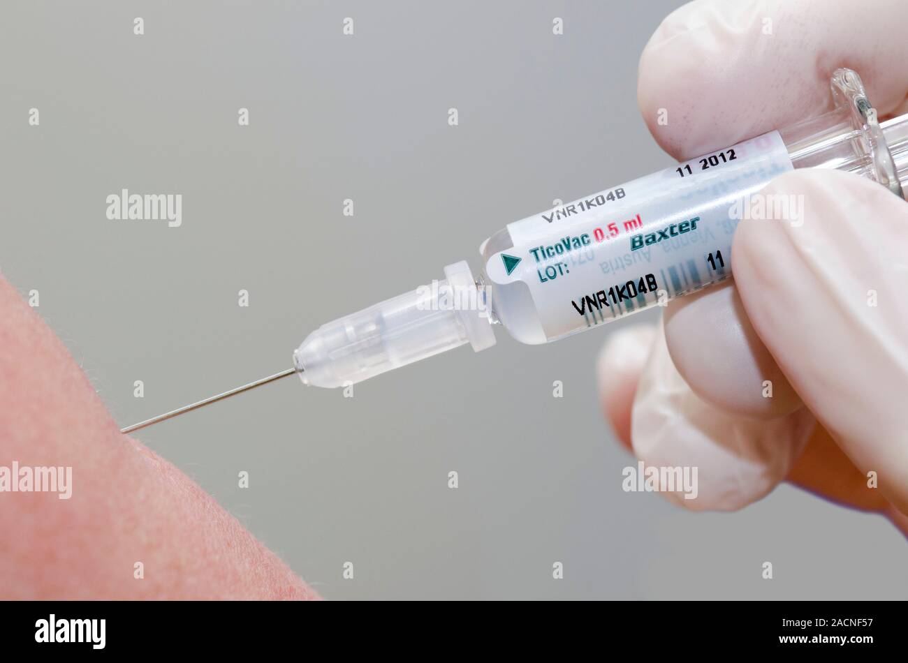 Tick Injection TicoVac tick-bourne encephalitis vaccine. Health worker injecting a ...