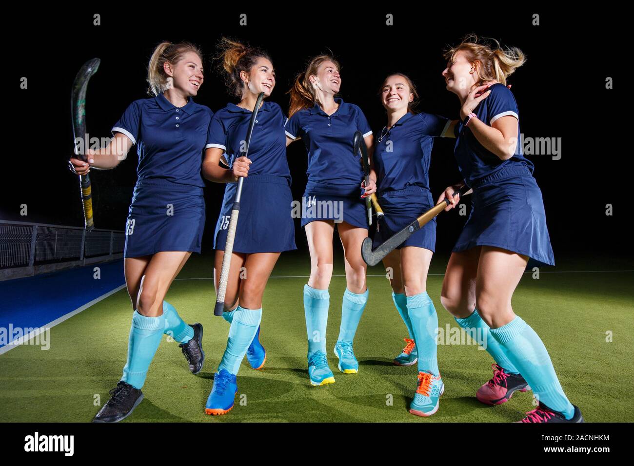 Group of female field hockey players celebrate the victory Stock Photo