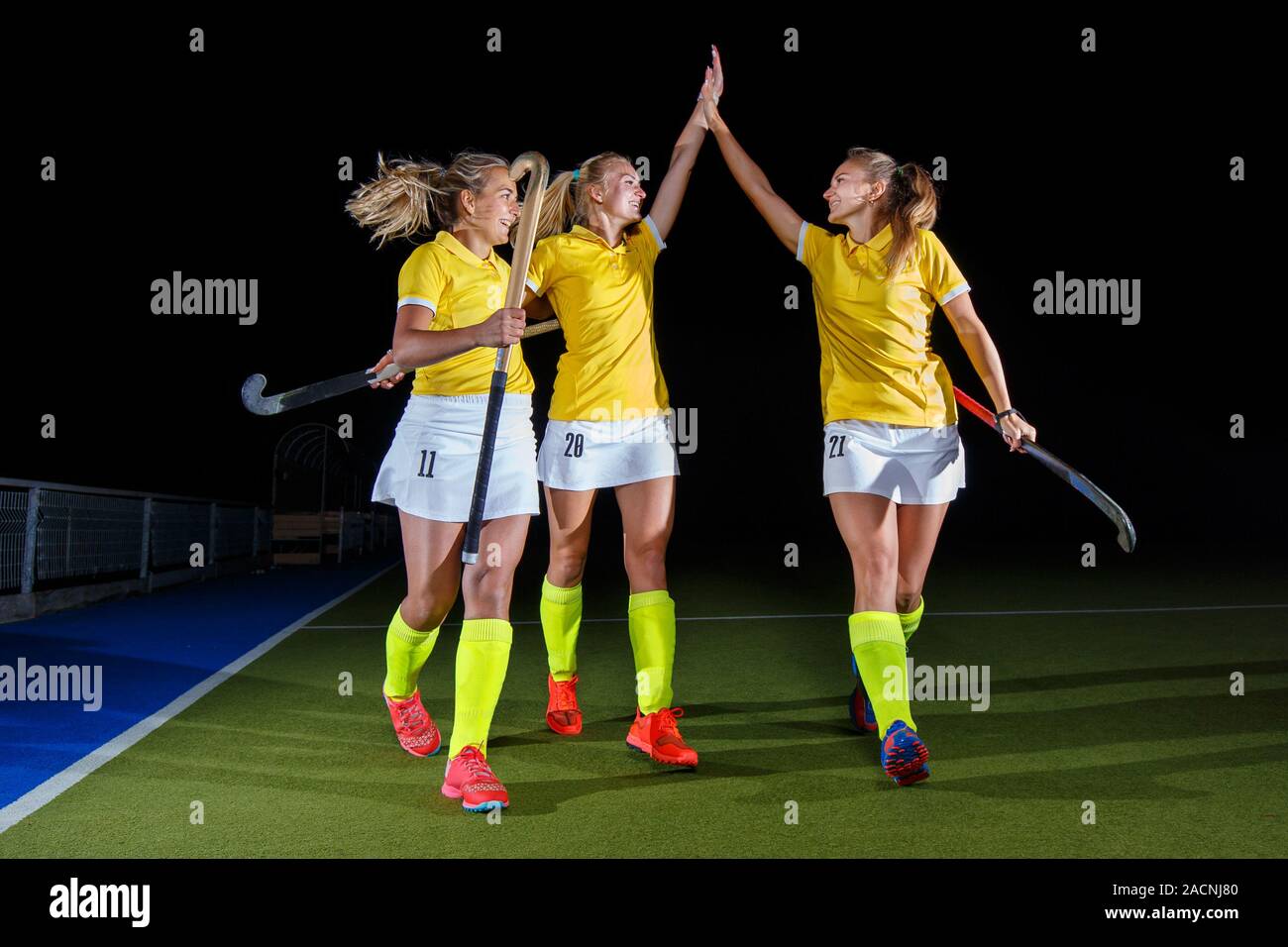 Group of female field hockey players celebrate the victory Stock Photo