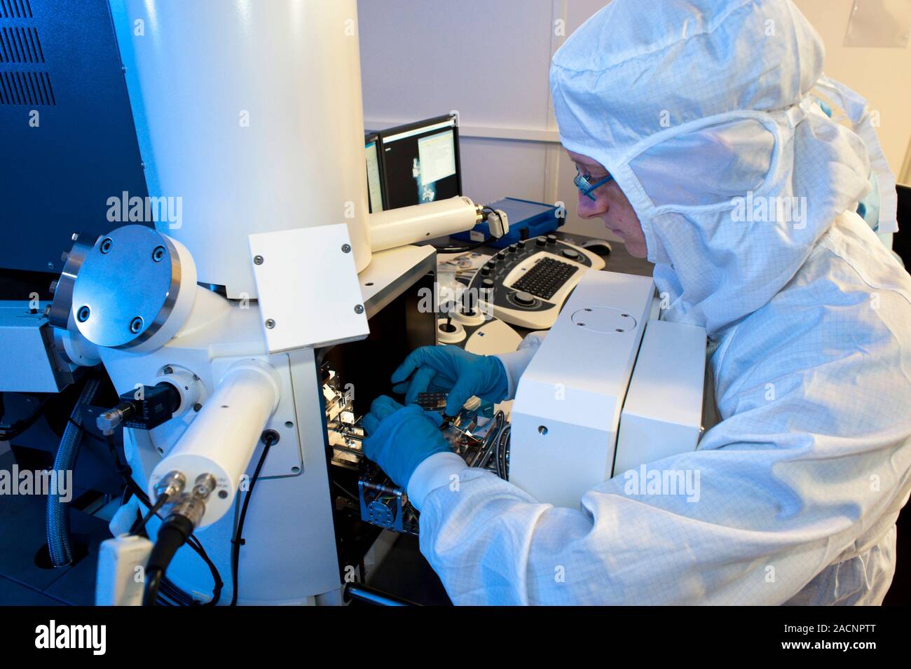 Manufacture of artificial retinas. Technician using an electron ...