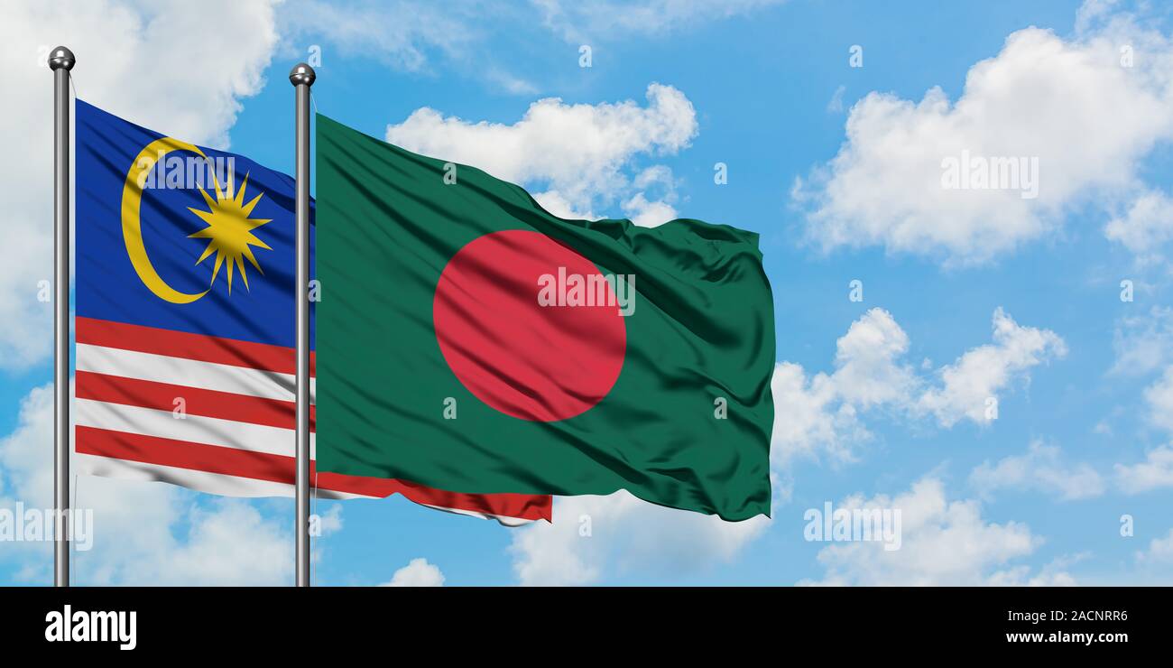 Malaysia and Bangladesh flag waving in the wind against white cloudy ...
