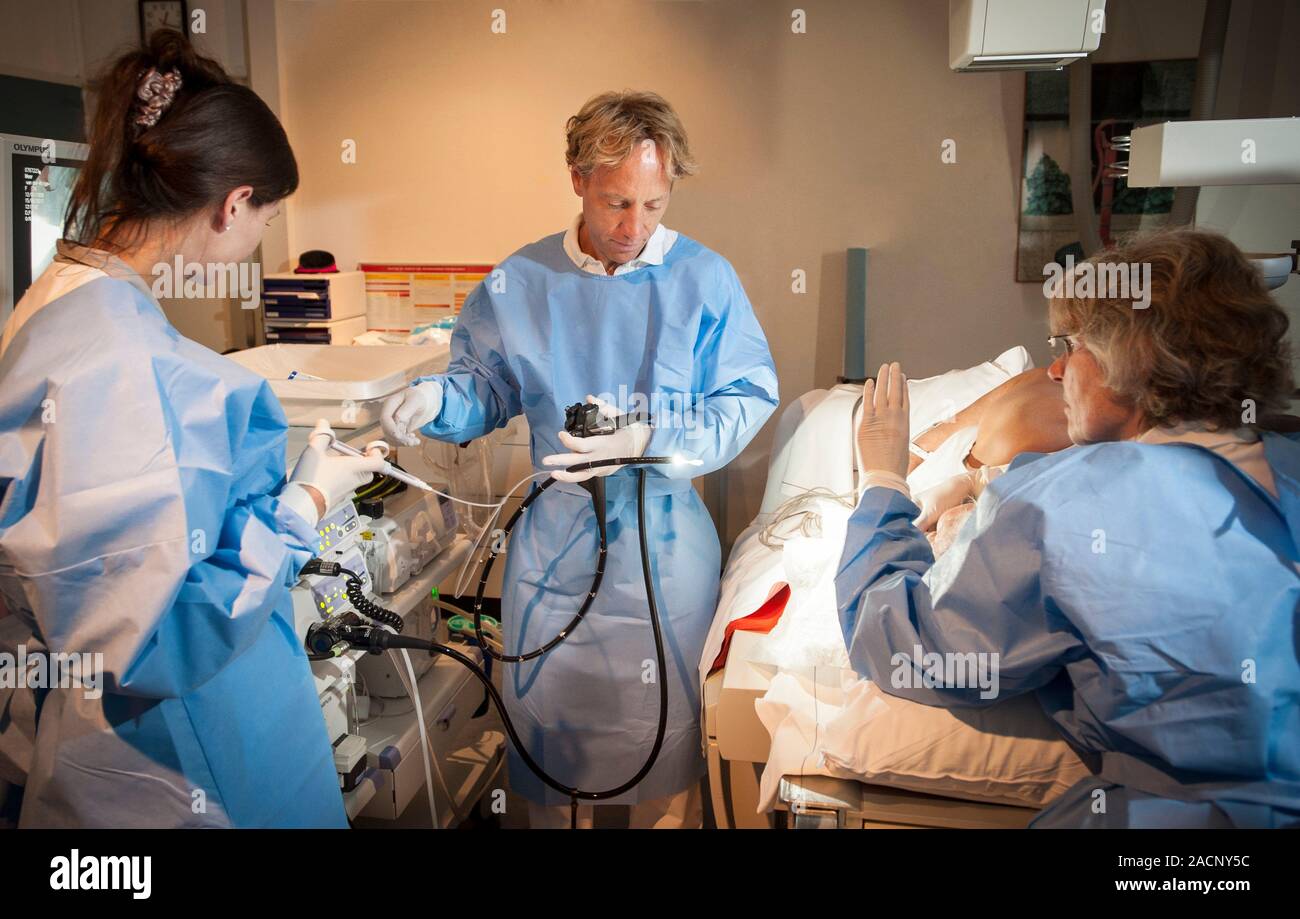 Endoscopy. Doctor preparing an endoscope for use on a patient ...