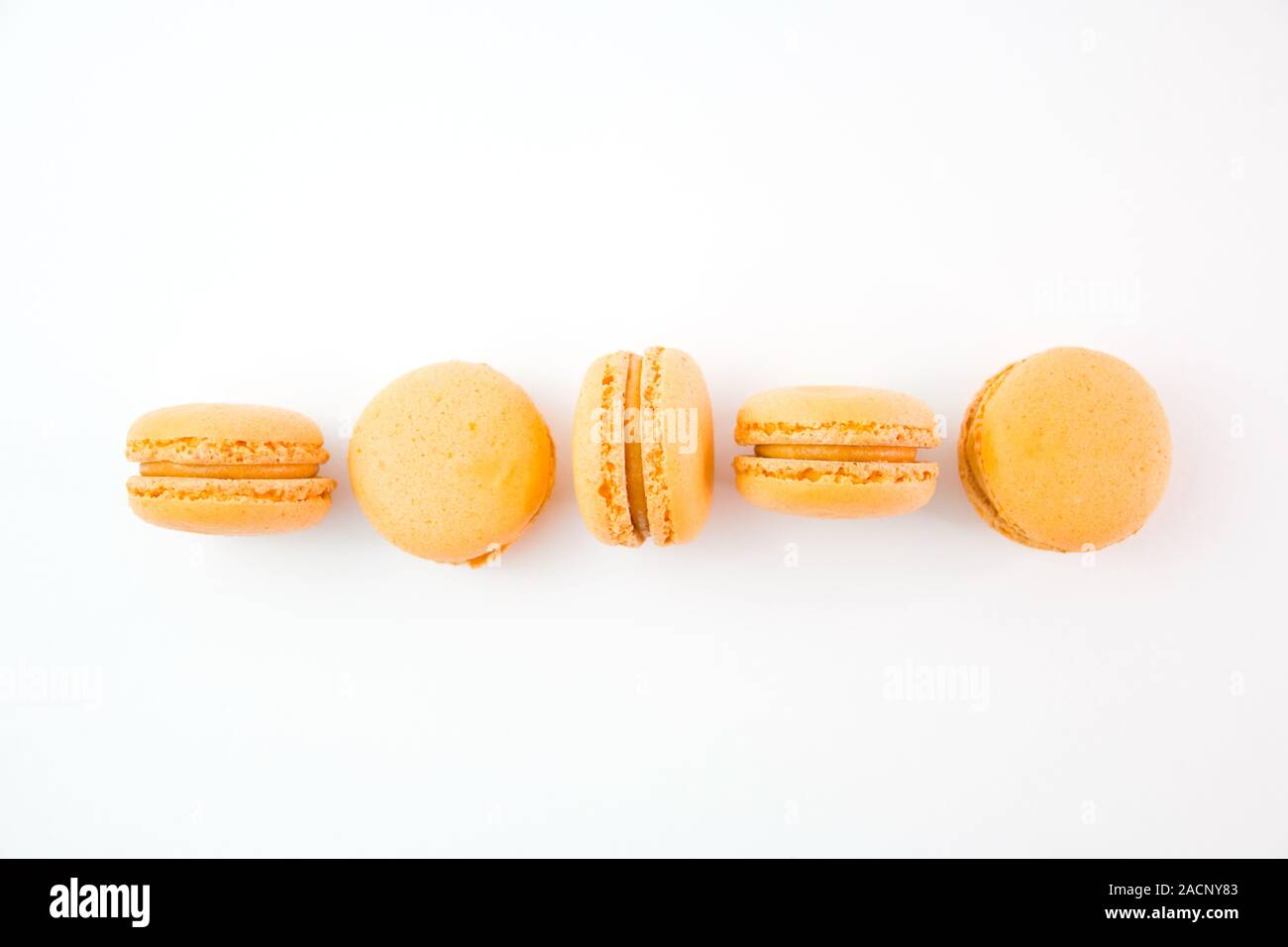Macaroons on white background top, colorful yellow macaroons, selective focus. Stock Photo