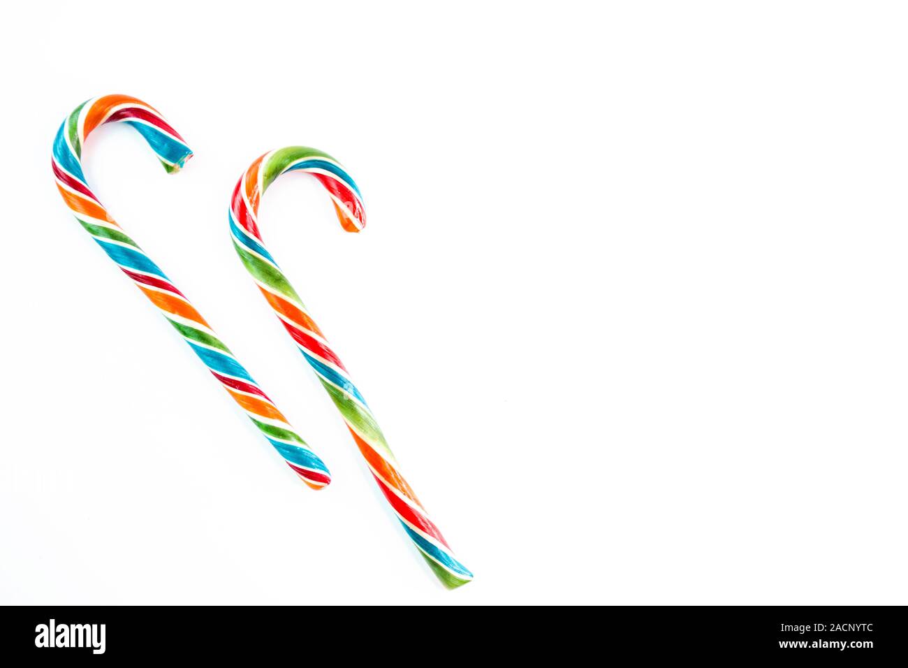 Two colorful festive Lollipop on white background selective focus top of view. Stock Photo