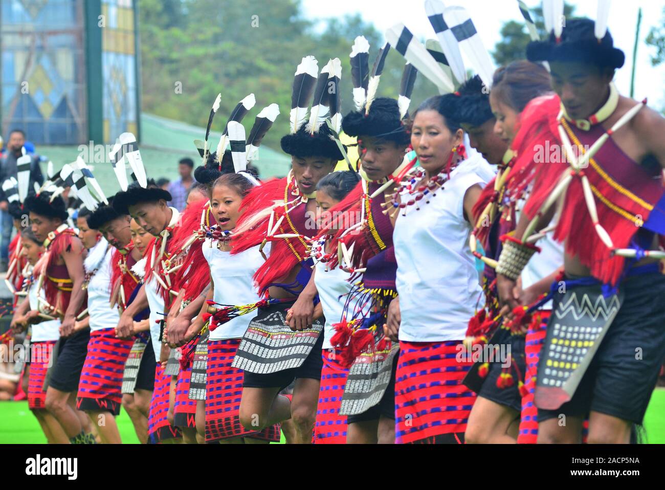 Kohima, India. 03 Dec 2019: Ao tribesmen perform a dance on the third day of the State annual Hornbill festival at Naga Heritage Village Kisama, some 15 kms away from Kohima, the capital city of the India north eastern state of Nagaland. The annual Hornbill festival of Nagaland celebrates the cultural heritage of the Nagas. Credit: Caisii Mao/Alamy Live News Stock Photo