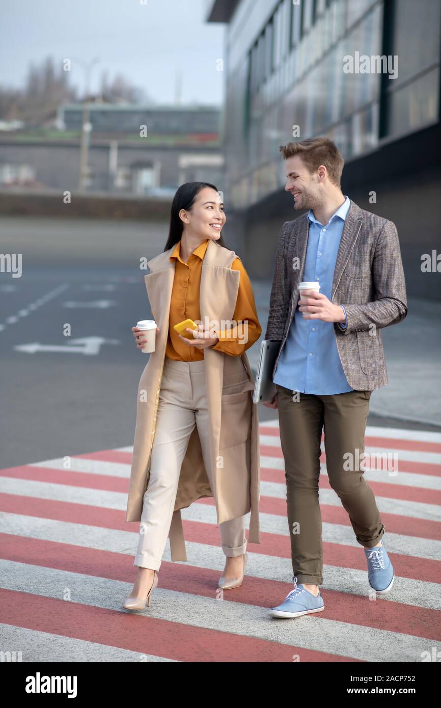 Man and woman talking in the street next to the business center Stock ...