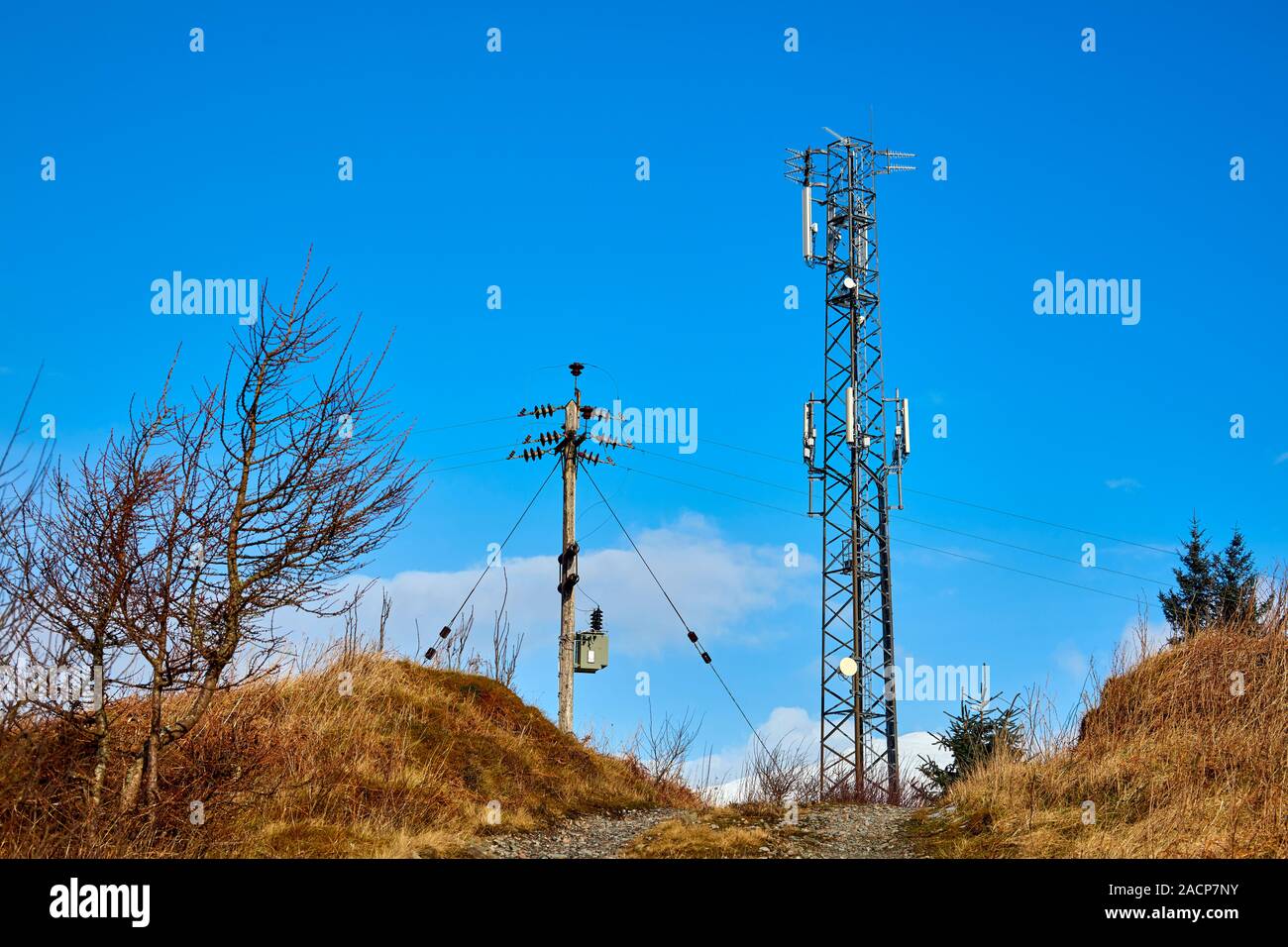 Hilltop communication mast TV UHF transmitter and telegraph pole, Dalmally, Scotland Stock Photo