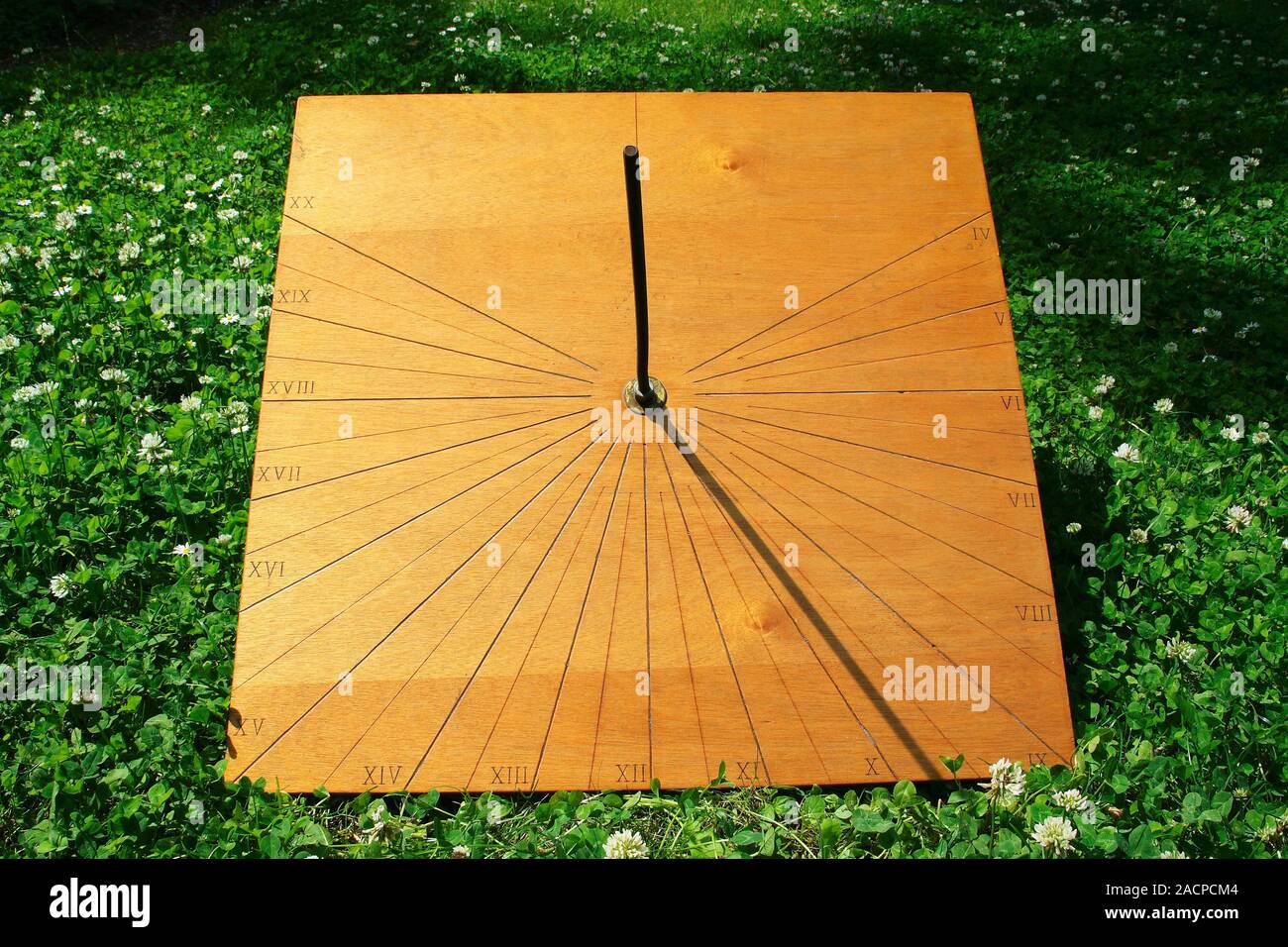 Equatorial sundial. On equatorial sundials, the planar surface that receives the shadow is exactly perpendicular to the gnomon's style (central bar). Stock Photo