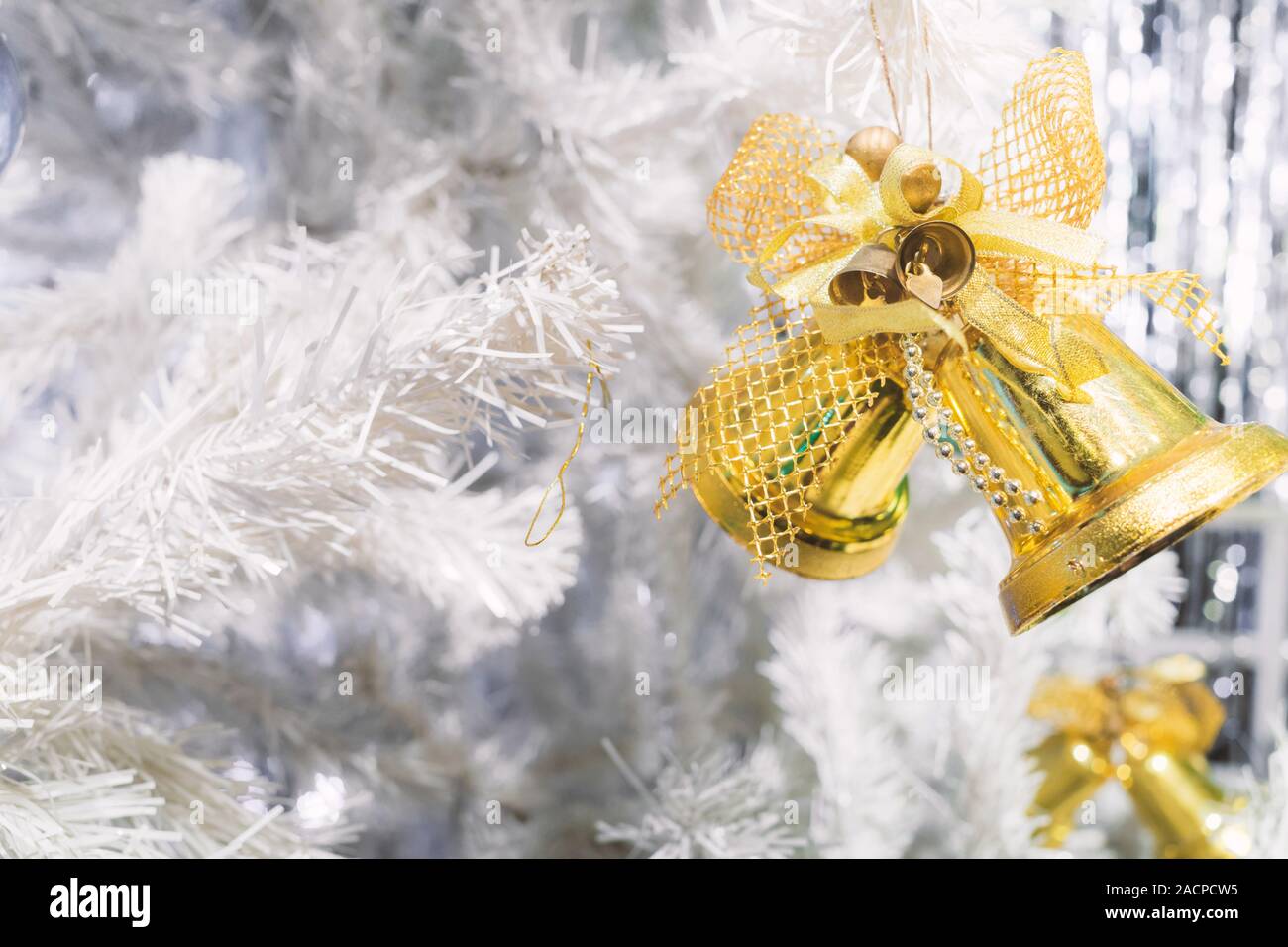 Christmas Tree with golden Bell and Gold Background Stock Photo - Alamy
