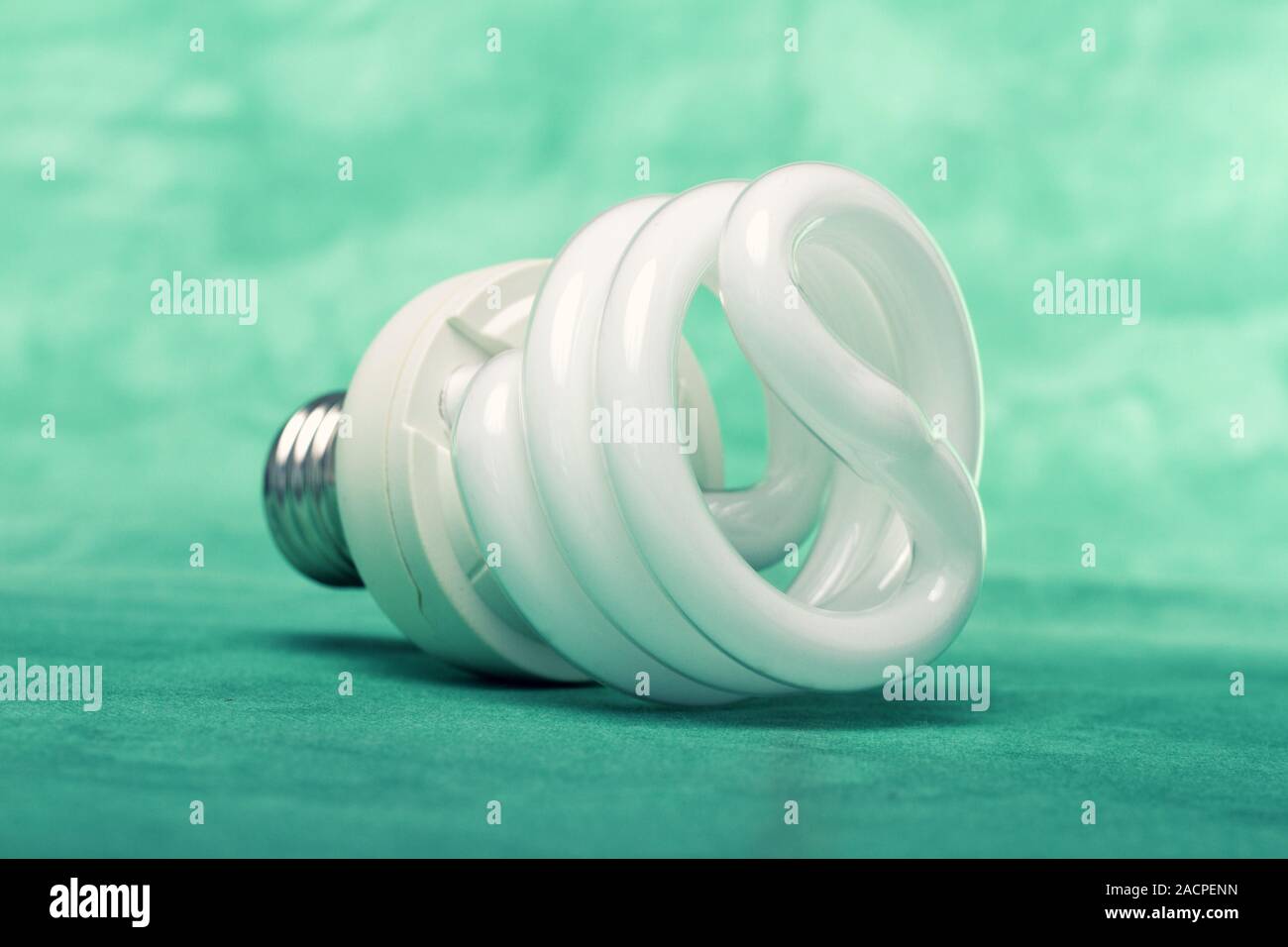 Light bulb on green background Stock Photo - Alamy
