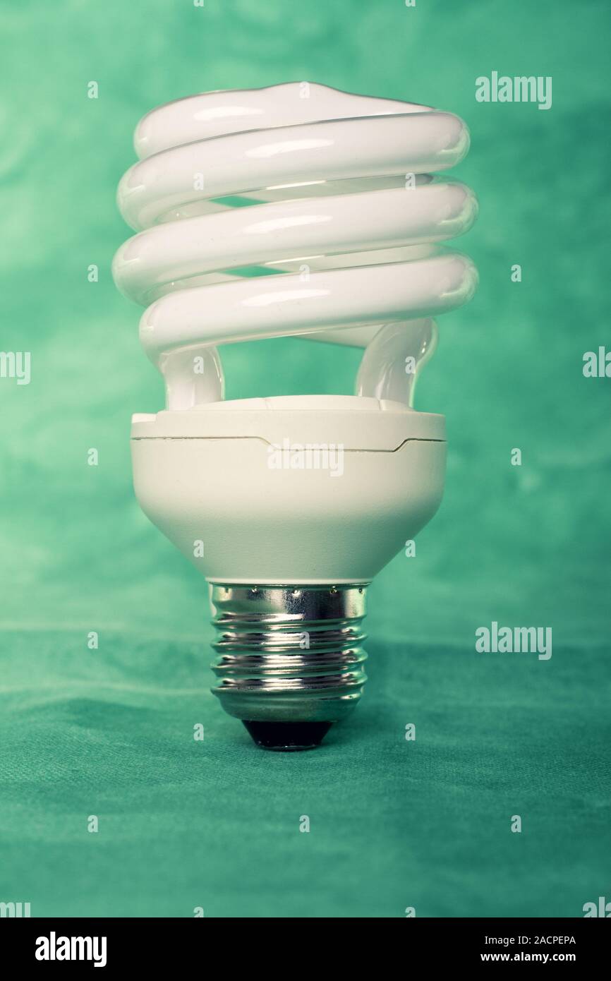 Light bulb on a green background Stock Photo - Alamy