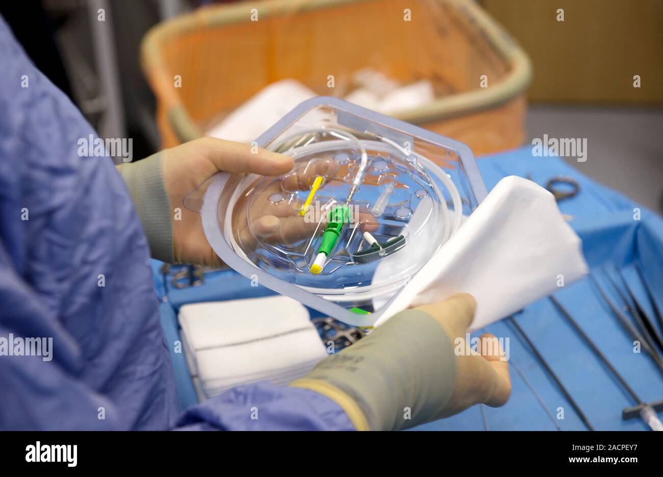 Implantable defibrillator surgery. Surgeon unpacking during surgery to