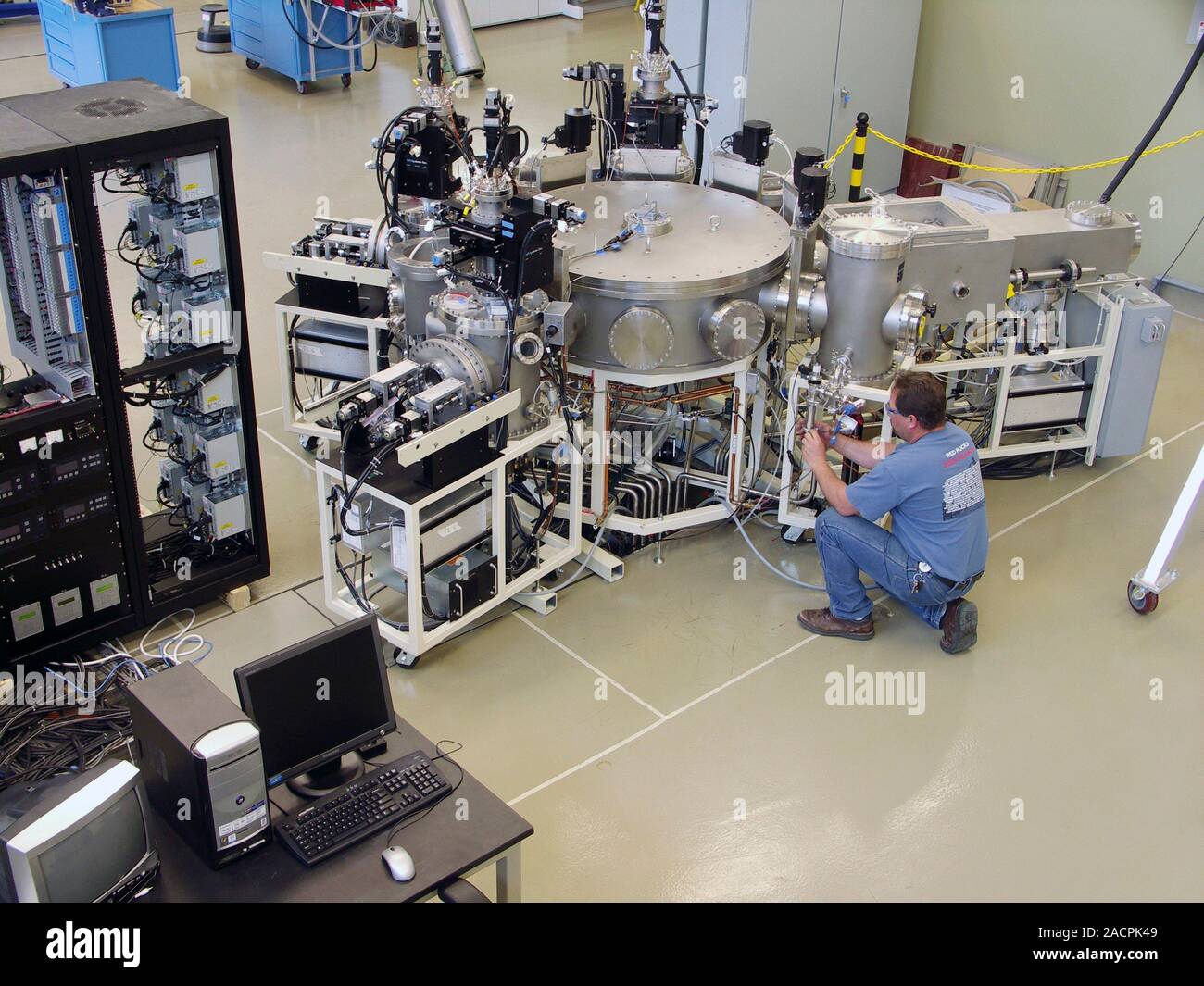 Silicon cluster manufacturing tool. Technician working on a silicon ...