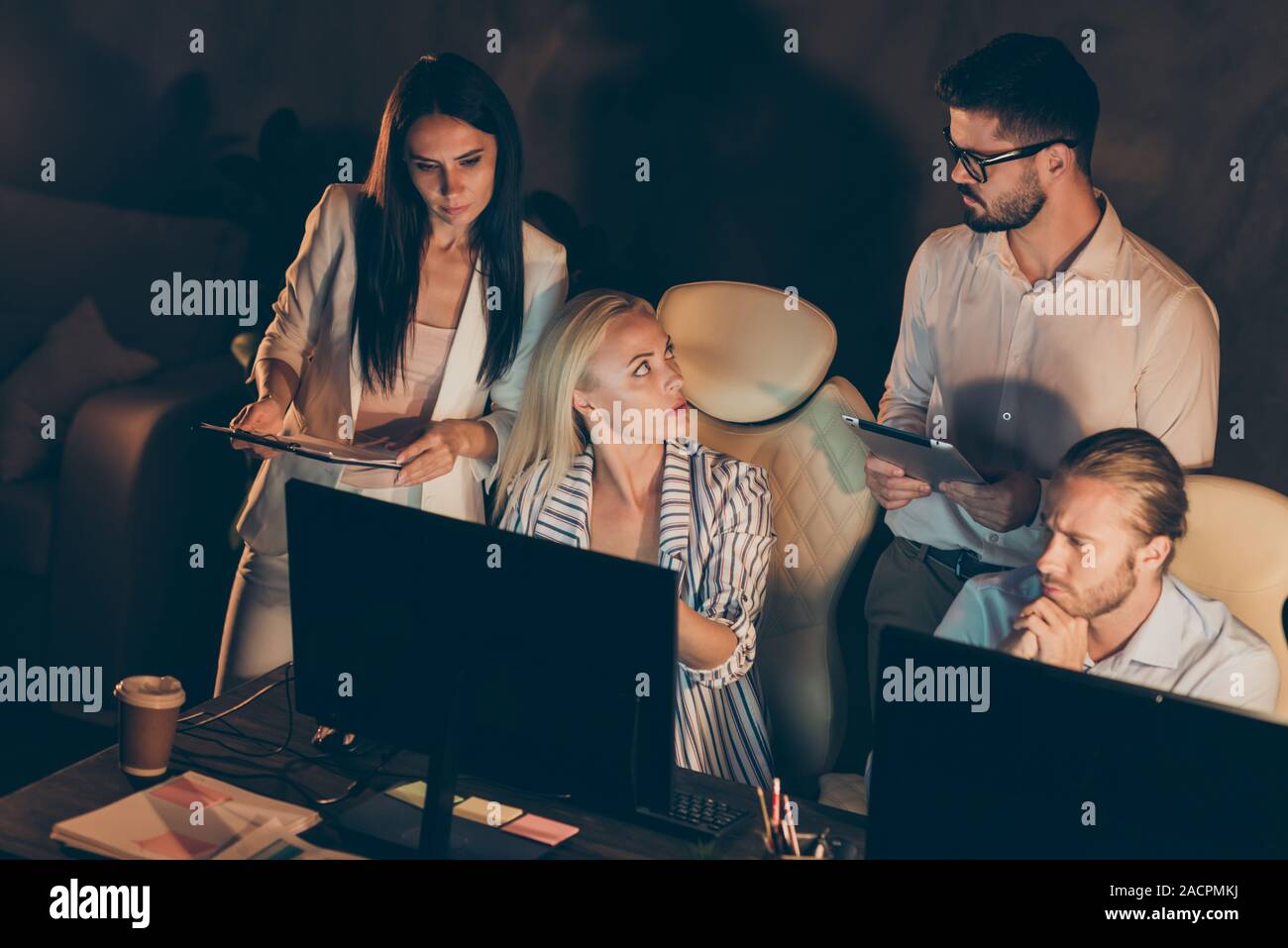 Portrait of nice attractive smart clever skilled intellectual hardworking coworkers specialists developing new launch solving finance issue late at Stock Photo