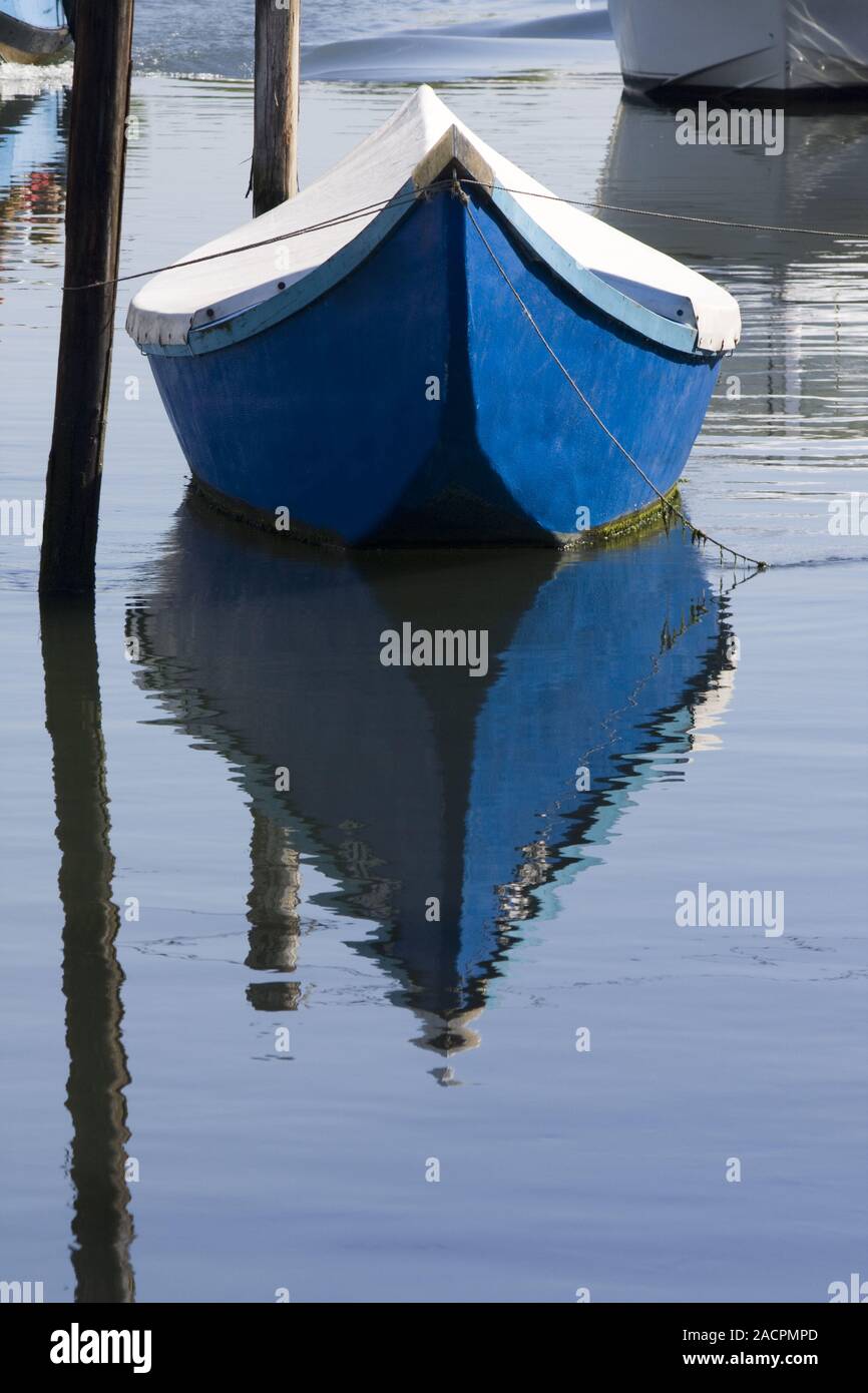 Blue boat on water Stock Photo