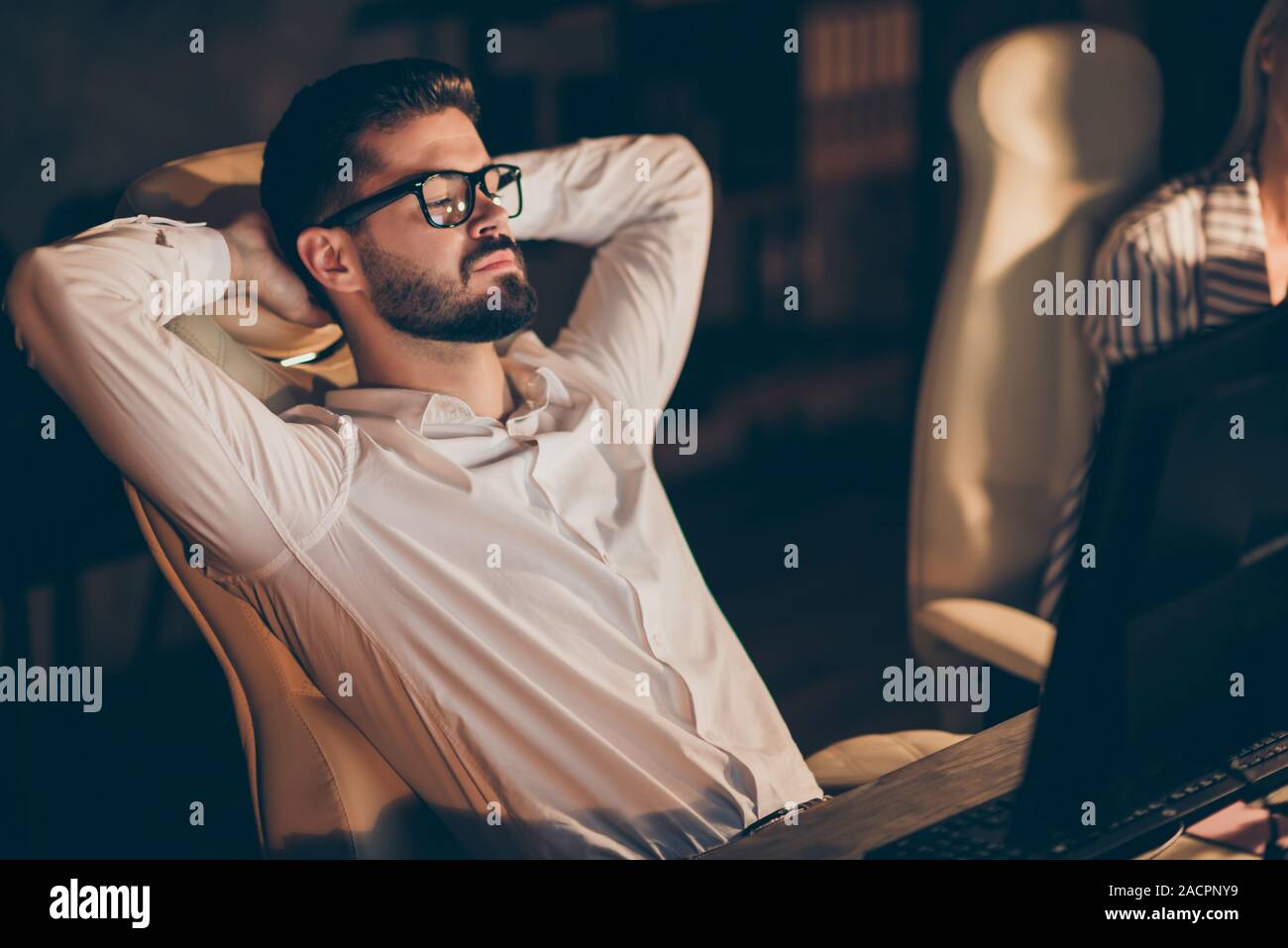 Portrait of his he nice attractive chic intellectual successful guy company owner founder sitting in chair working late evening having pause break at Stock Photo