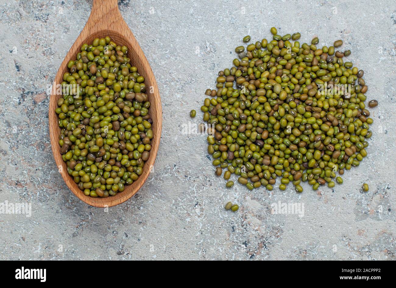 green beans in a wooden spoon, gray background, closeup, copy space. Vigna radiata Stock Photo