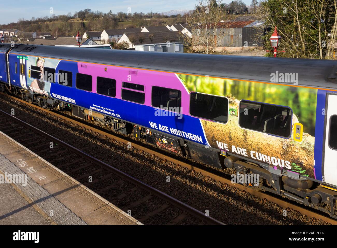 A section of a Northern Rail class 158 diesel multiple unit passenger train featuring their 'We are Northern' marketing campaign. Stock Photo