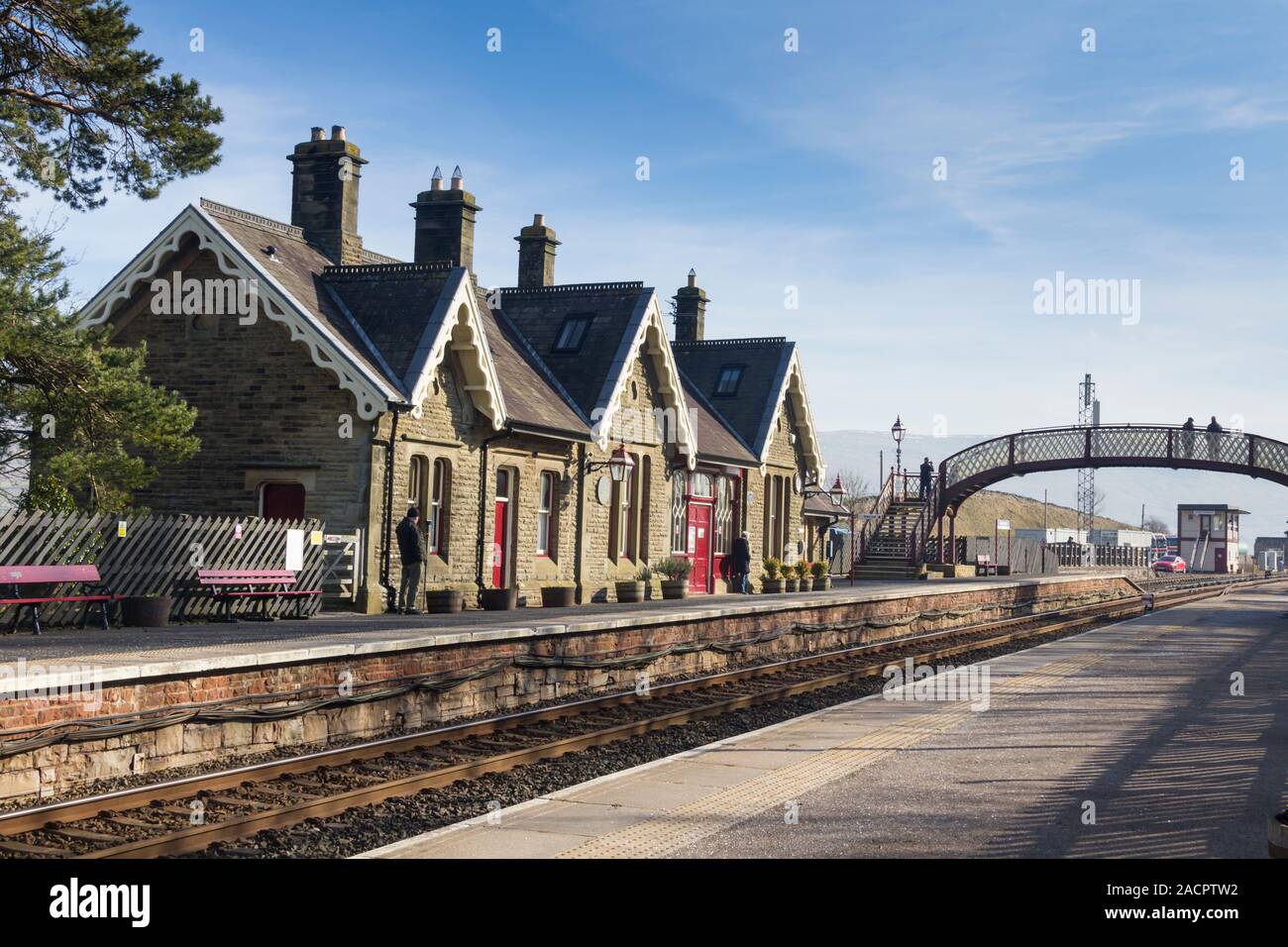 The railway station at Kirkby Stephen in Cumbria on a bright winter afternoon, looking in the southbound direction. Stock Photo