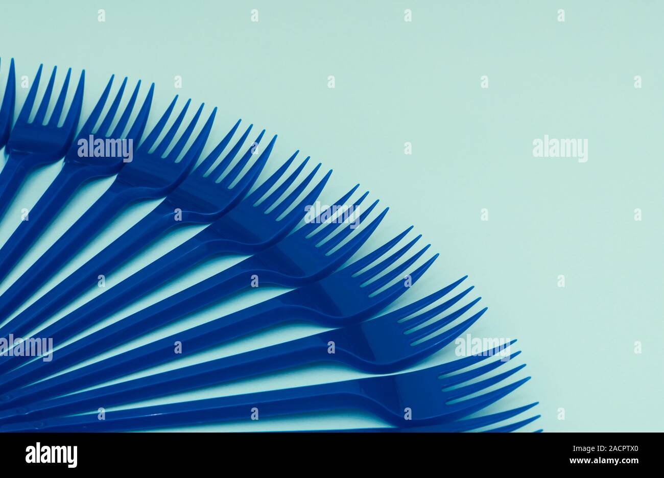 Blue plastic forks on a blue background, gorizontal orientation, copy space Stock Photo