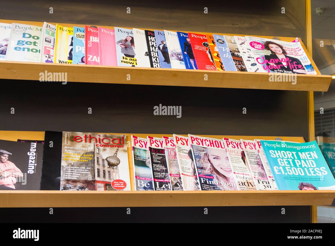 Psychologies and People Management magazines on a magazine rack in Manchester University. 'Psychologies' is a monthly magazine on mindful living. Stock Photo