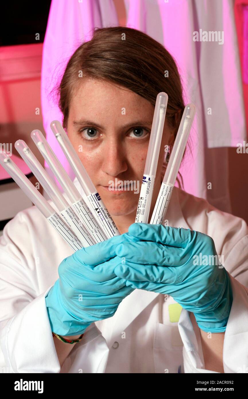 Forensic gunshot residue analysis. Forensic scientist holding swabs