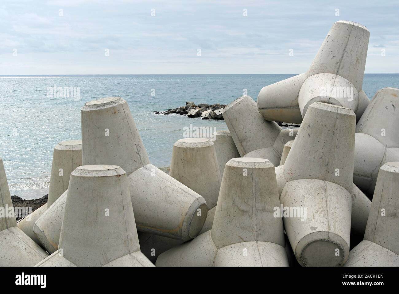 Coastal defences. Precast concrete blocks along a shore. This type of