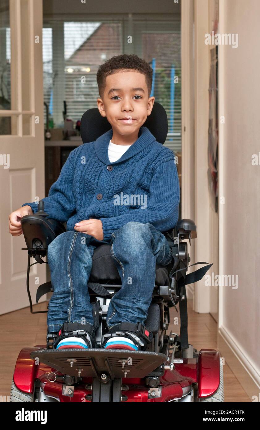 Child with muscular dystrophy in an electric wheelchair. Muscular