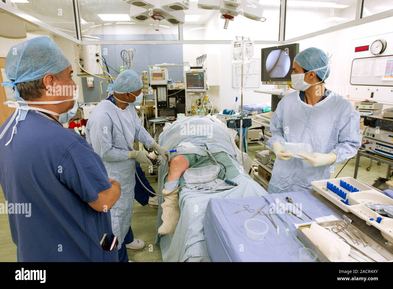 Knee arthroscopy. Surgeon using a keyhole arthroscopy (joint endoscopy