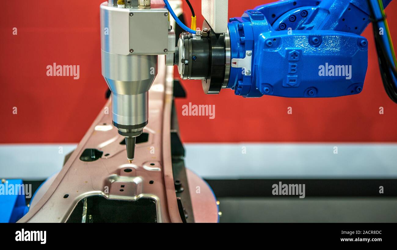 Robotic arms works on factory on manufacture of cars. Industrial robotic welders weld the car body. Machine robot arm. Smart industry. Automobile prod Stock Photo
