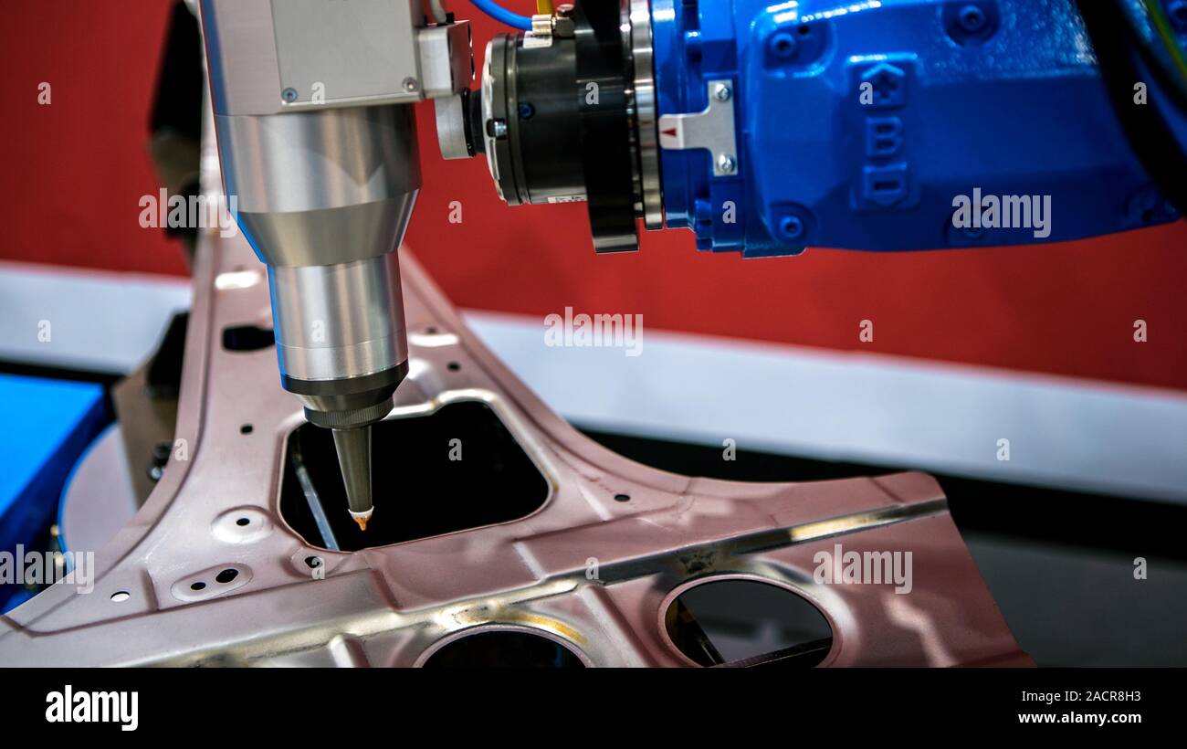 Robotic arms works on factory on manufacture of cars. Industrial robotic welders weld the car body. Machine robot arm. Smart industry. Automobile prod Stock Photo