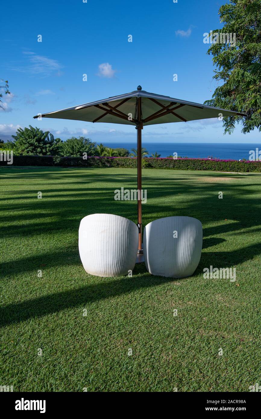 garden furniture overlooking the sea on Maui Stock Photo