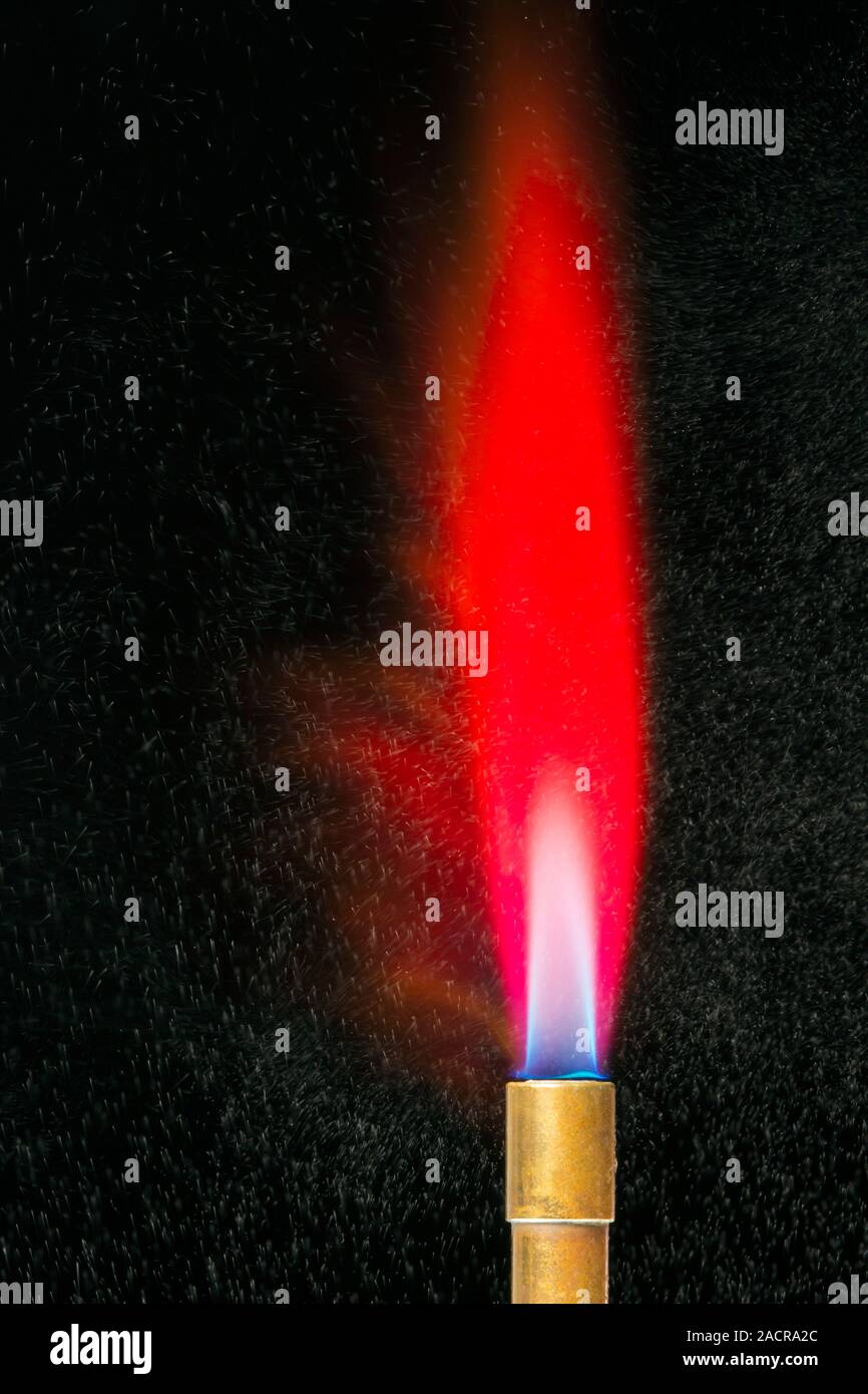 Lithium flame test. Mixture of water and a lithium salt being sprayed