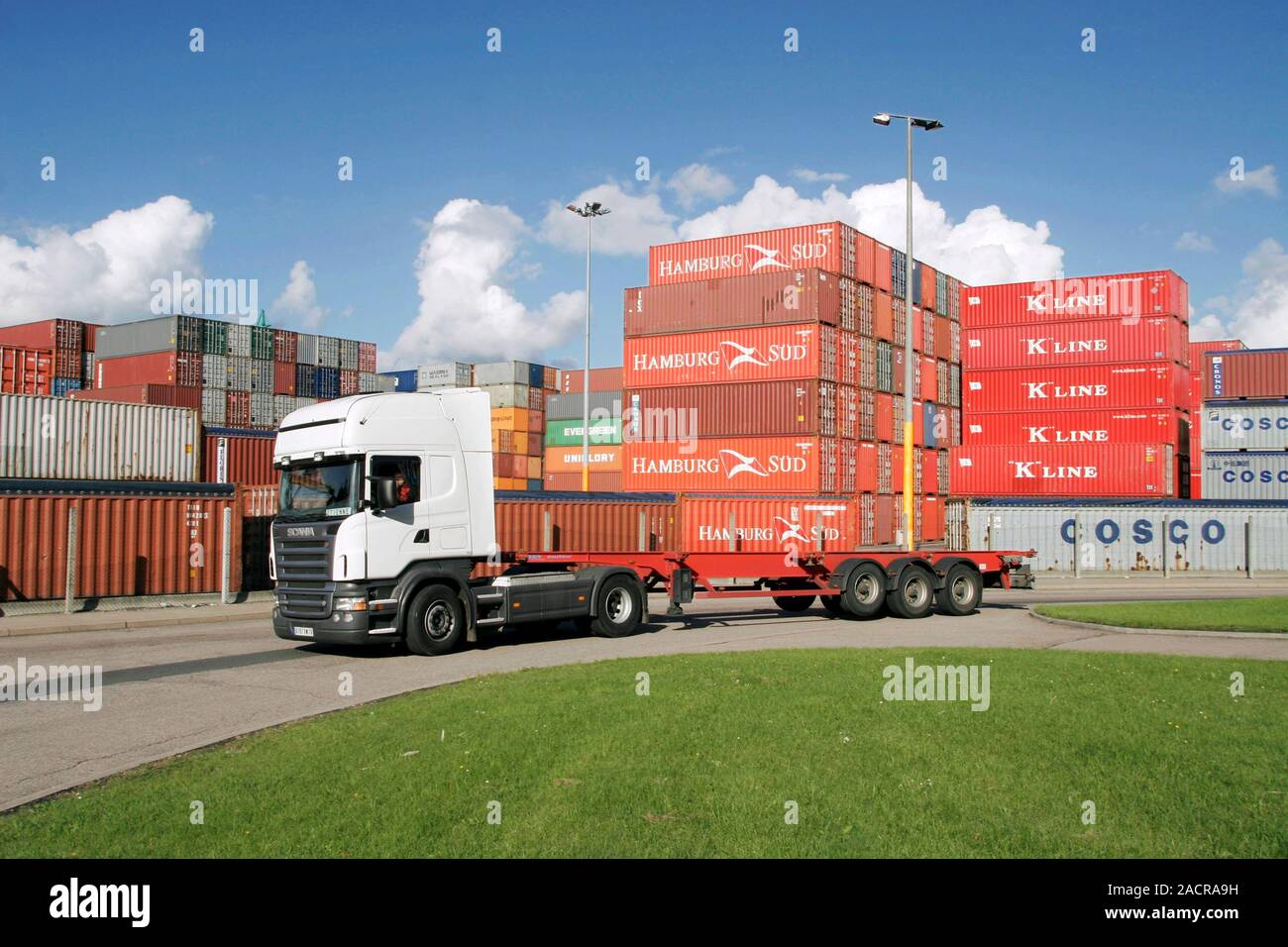 Container port. Unladen truck in front of shipping containers stacked ...
