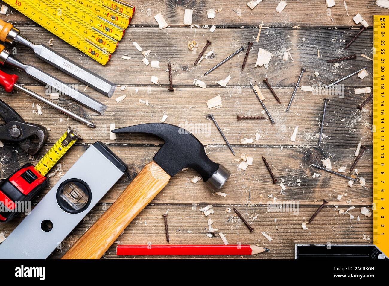 Top view of carpenter's tools on an antique wooden table. Construction industry, do it yourself. Wooden work table. Stock Photo
