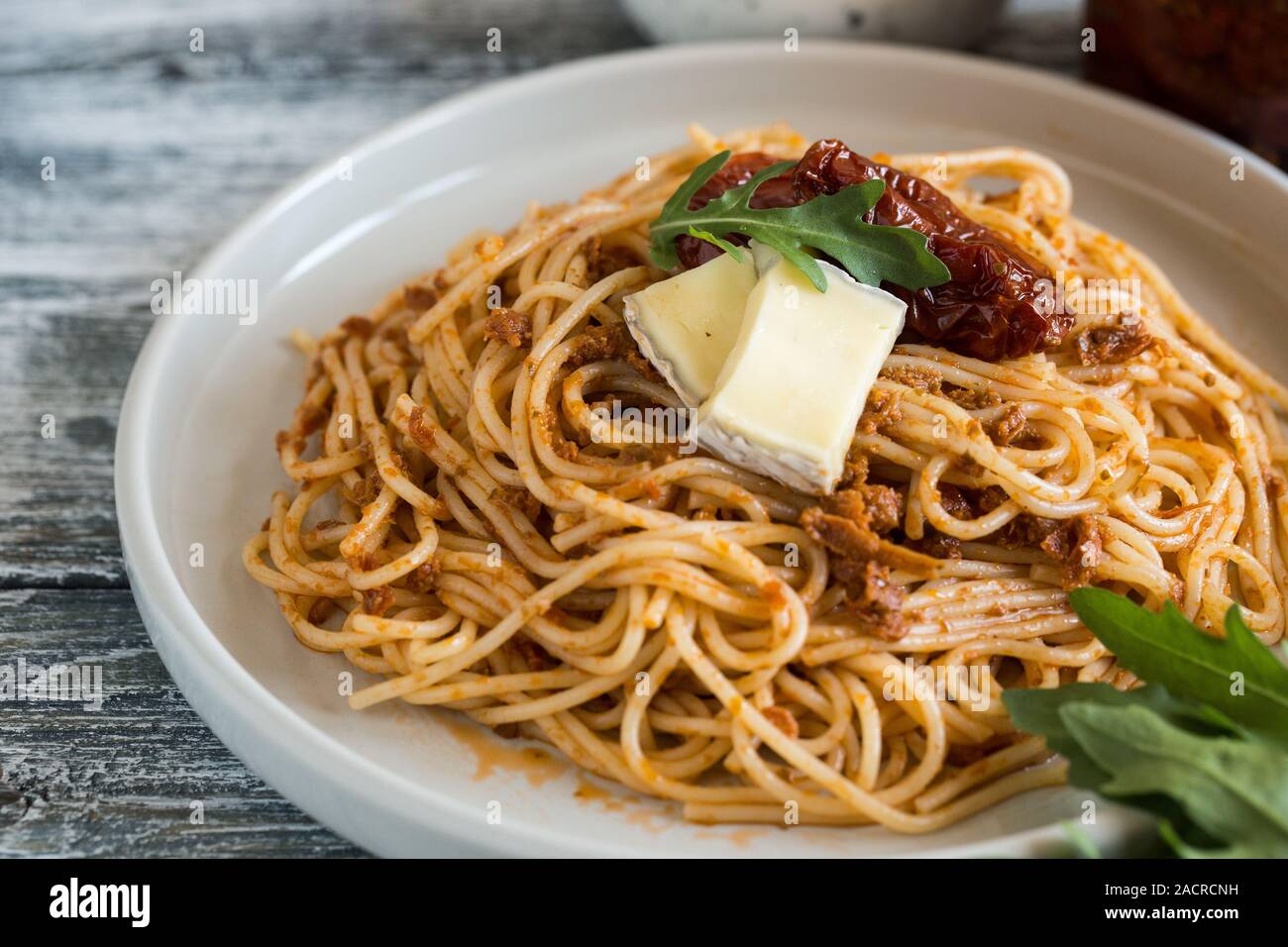 Italian Pasta with sundried tomato pesto and brie cheese Stock Photo