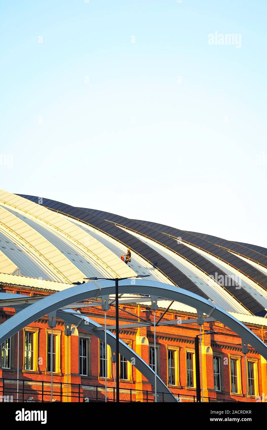 Maintenance men working on the roof of Manchester Central Conference and exhibition Centre Stock Photo