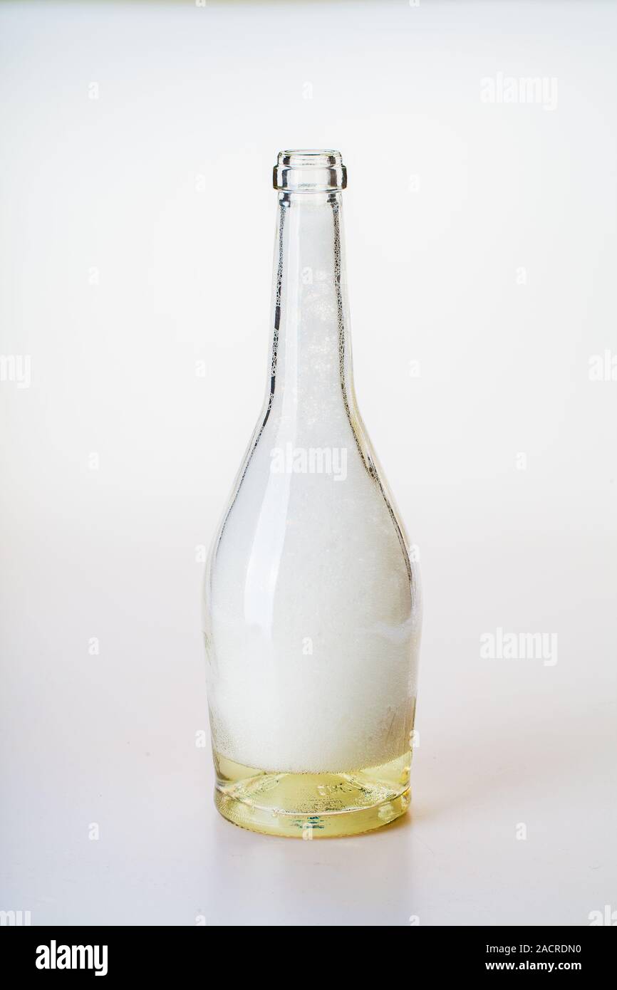 clear glass bottle with white foam Stock Photo