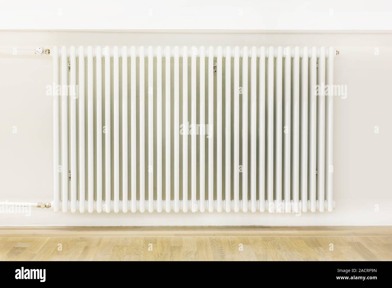 Large radiator in renovated room Stock Photo - Alamy