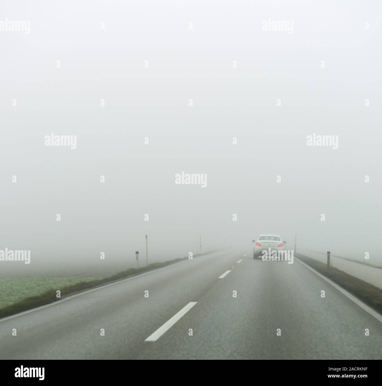 Fog on a road with cars Stock Photo