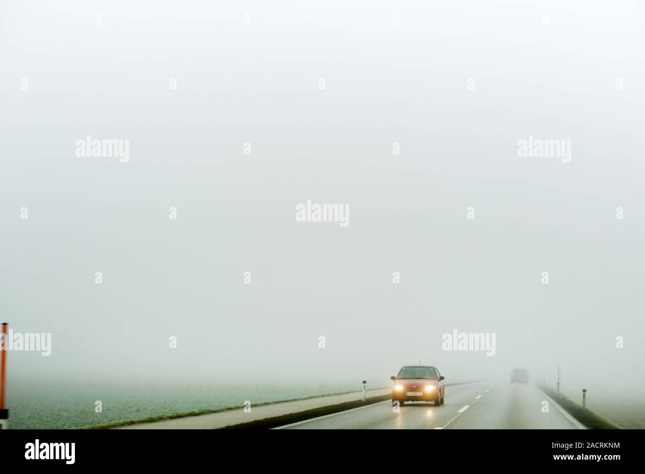 Fog on a road with cars Stock Photo