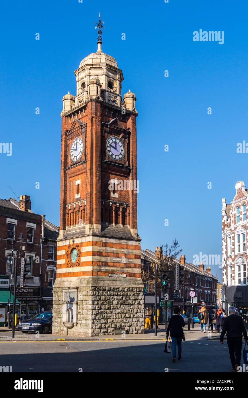 Crouch End clock tower, by Frederick Knight, 1895, plaque by Alfred Gilbert, sculptor, and Broadway Parade, Hornsey, London, England Stock Photo